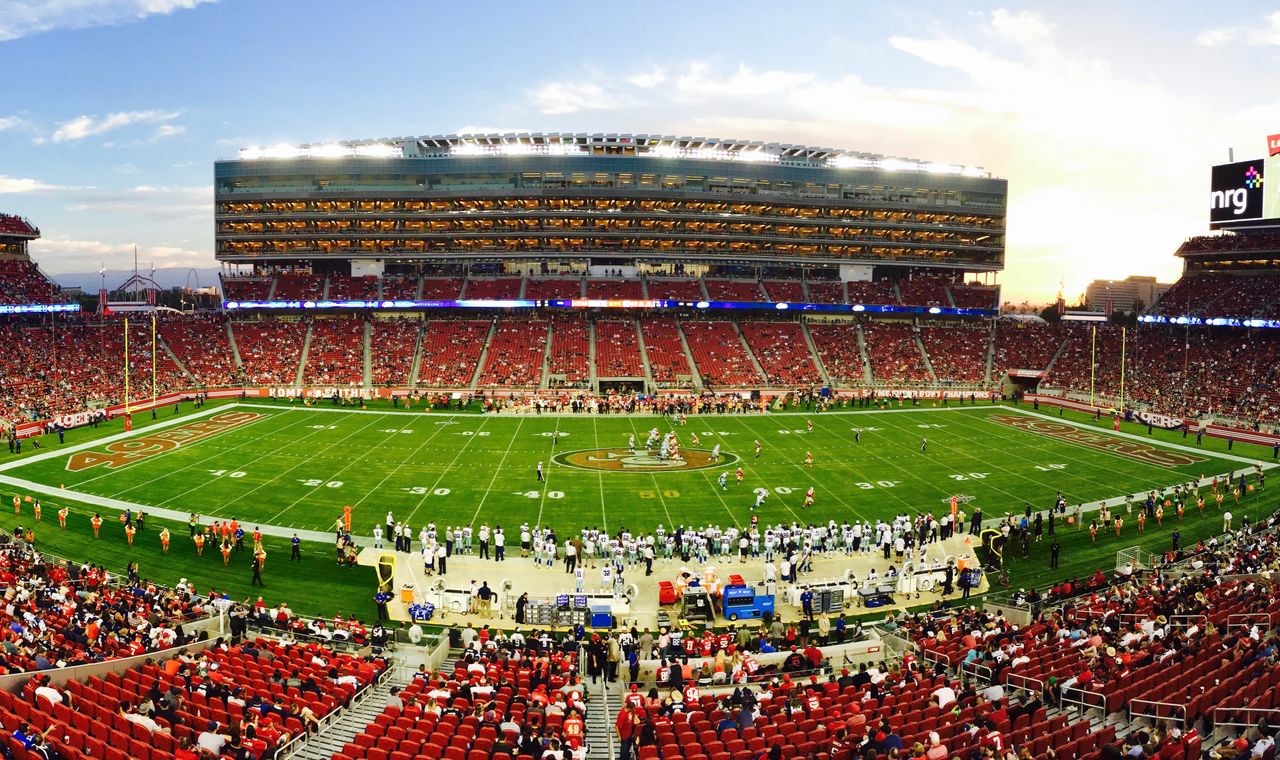 A packed crowd at Levi's Stadium in Santa Clara at sunset, the stadium district where FinTruction supports contractors with job costing and WIP