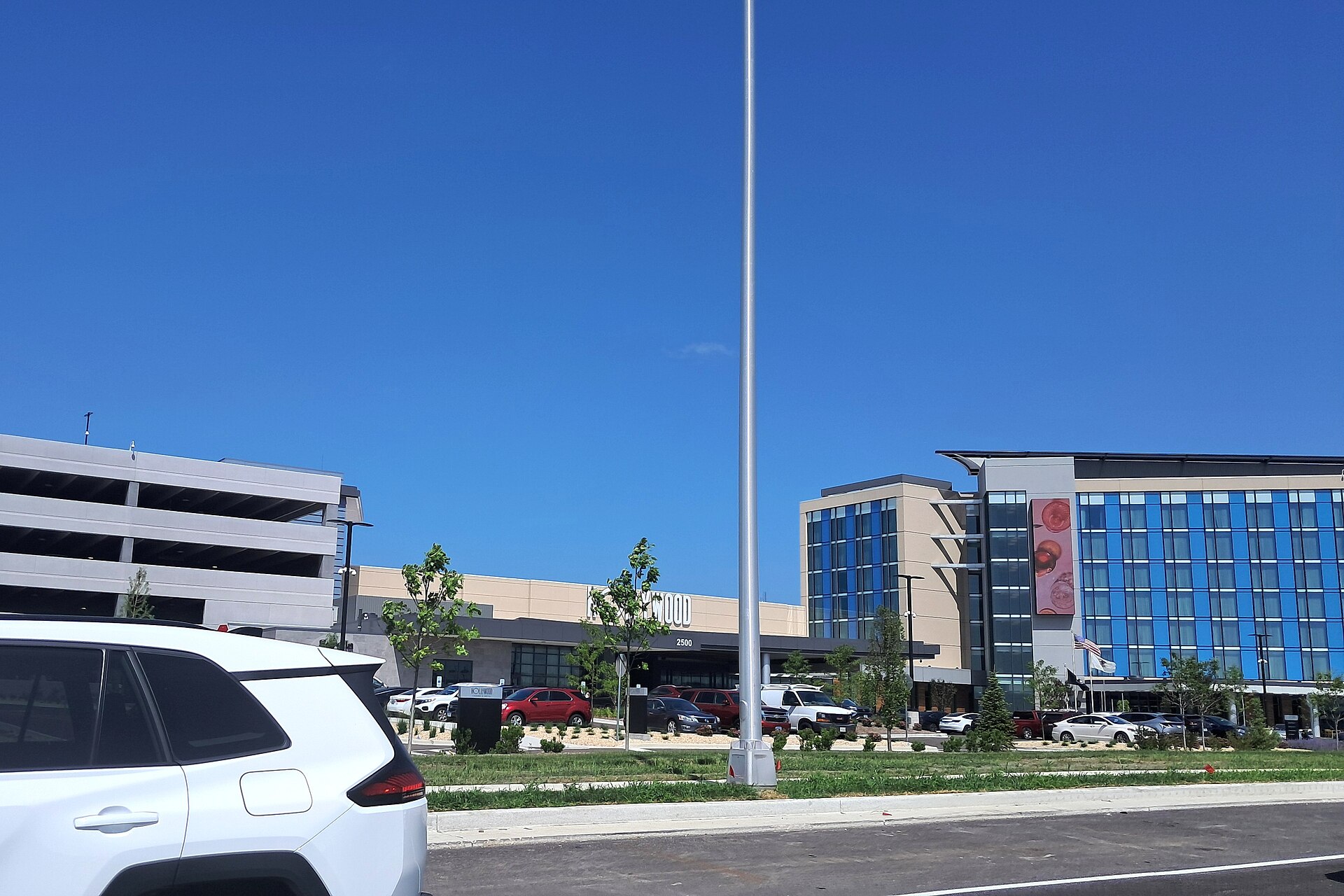 The Hollywood Casino Aurora resort with its glass hotel wing, concrete parking structure and newly planted landscaping seen from the road