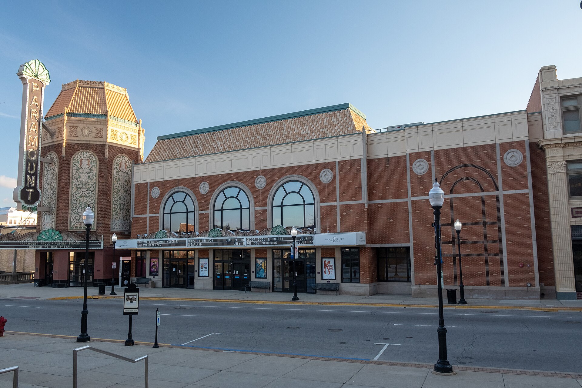 The Paramount Theatre on Stolp Avenue in downtown Aurora, Illinois, vertical marquee sign, glazed terra cotta tower and the brick Grand Gallery wing beside it