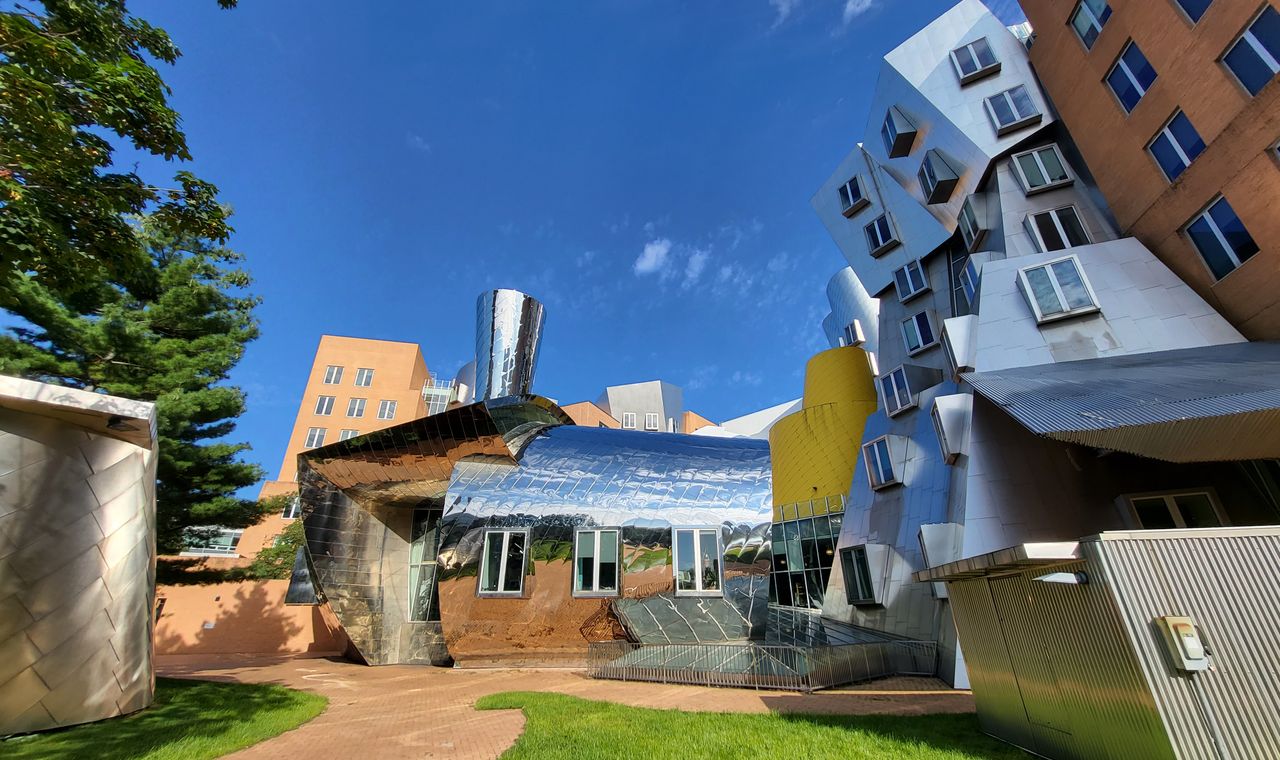 Angled stainless-clad and brick research buildings on the MIT campus in Cambridge, the lab construction market FinTruction serves