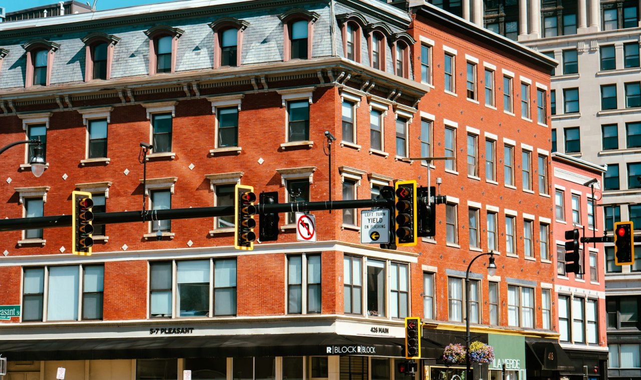 Older brick storefront blocks with a mansard roof at the corner of Main and Pleasant Streets in downtown Worcester, typical conversion stock