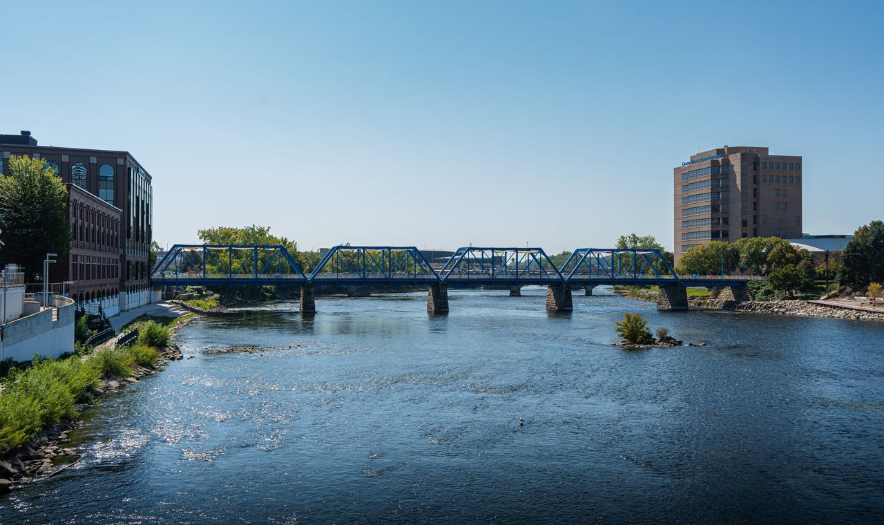 Blue Bridge crossing the Grand River in downtown Grand Rapids, the West Michigan market FinTruction serves with contractor bookkeeping
