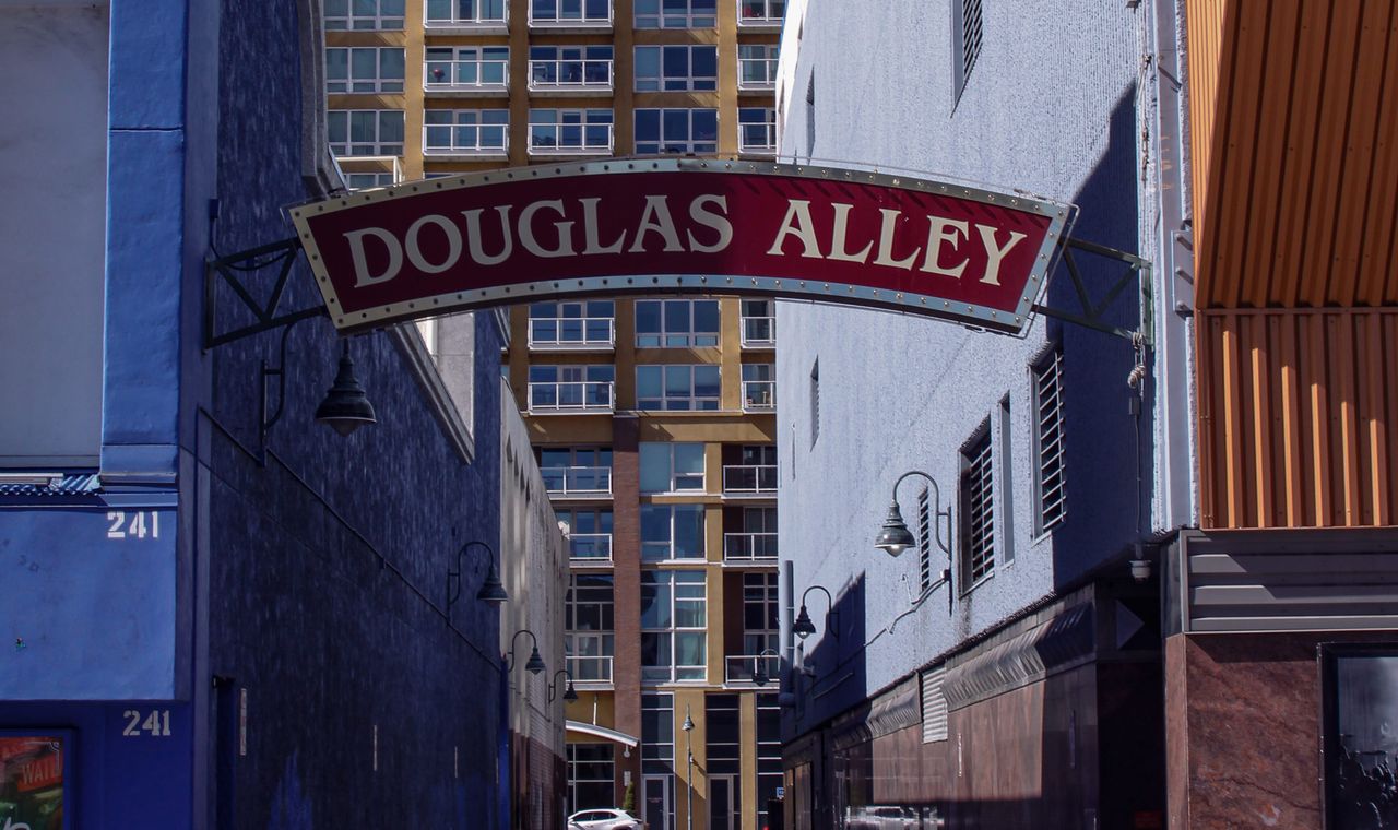 The Douglas Alley archway sign in downtown Reno with a new residential tower behind it, the Northern Nevada market FinTruction serves