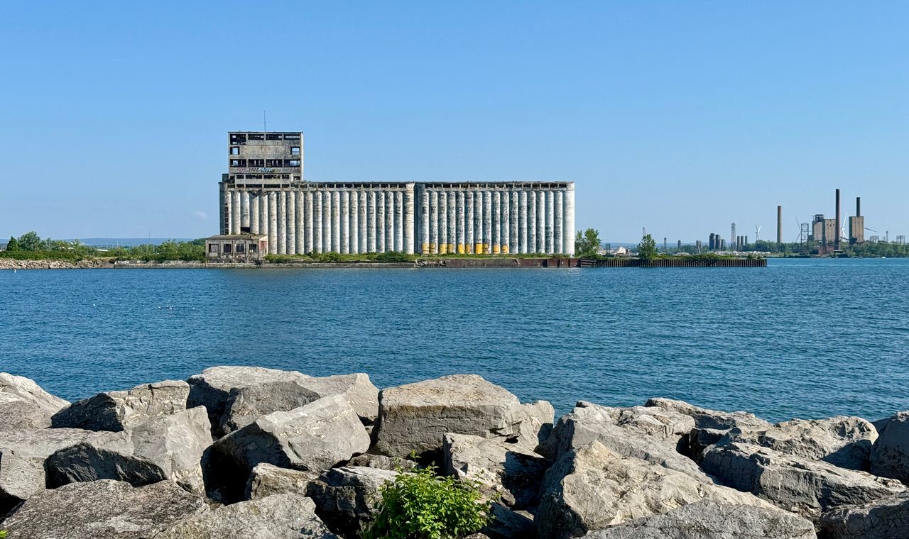 A disused concrete grain elevator on the Buffalo waterfront seen across the water, the adaptive-reuse stock behind Western New York job-cost coding