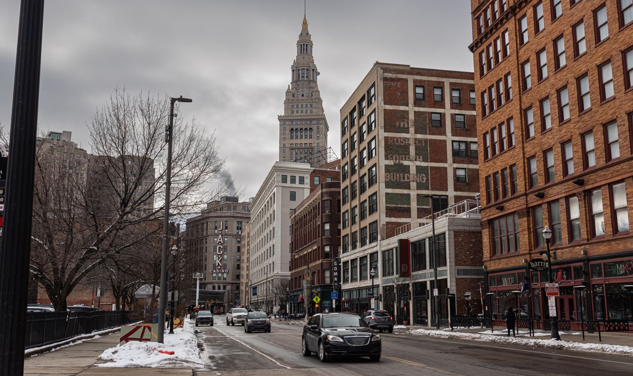 Snow along a downtown Cleveland street with Terminal Tower and century-old brick buildings behind, the market FinTruction keeps contractor books current in