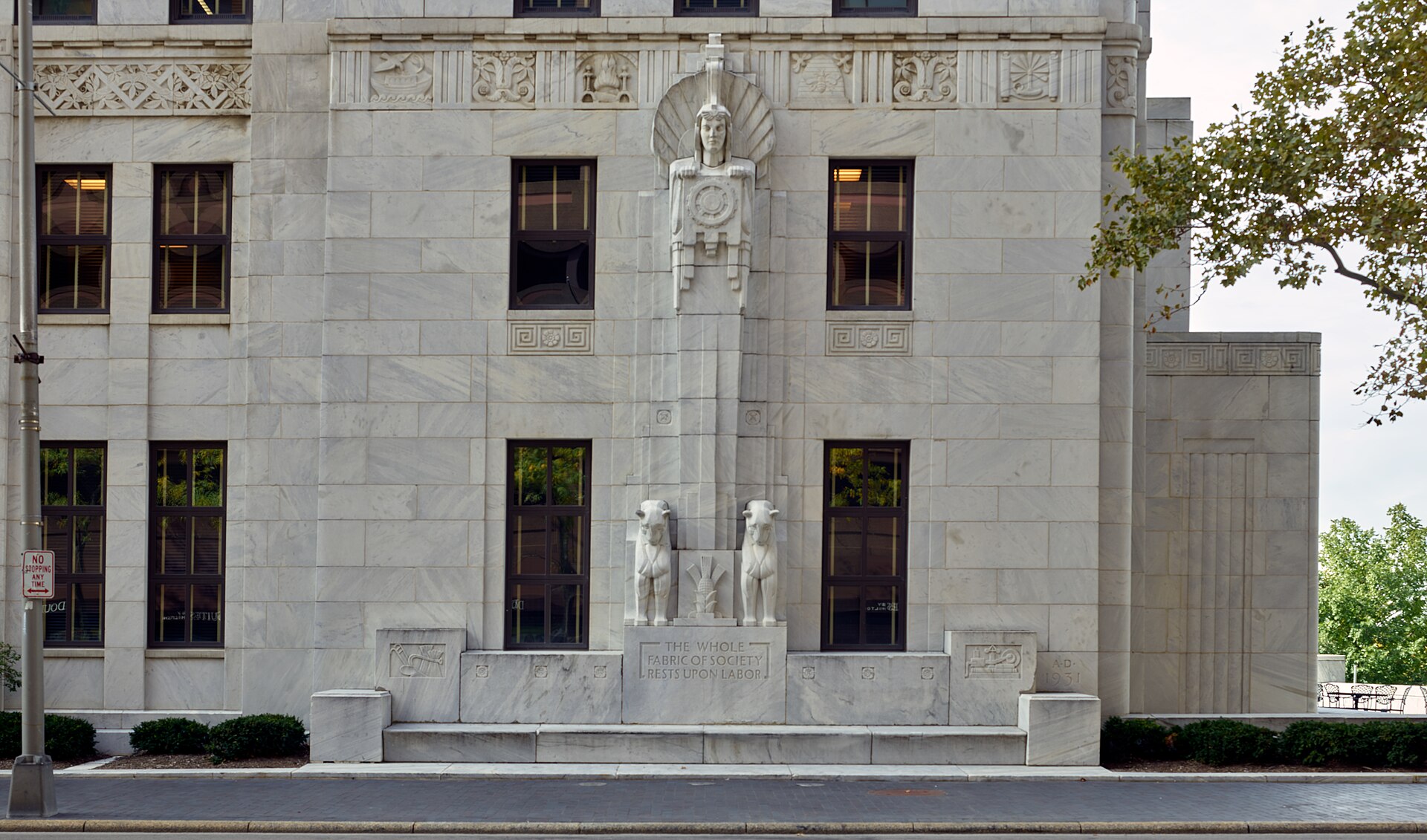 Art Deco marble facade in downtown Columbus carved with a robed figure and the inscription The Whole Fabric Of Society Rests Upon Labor