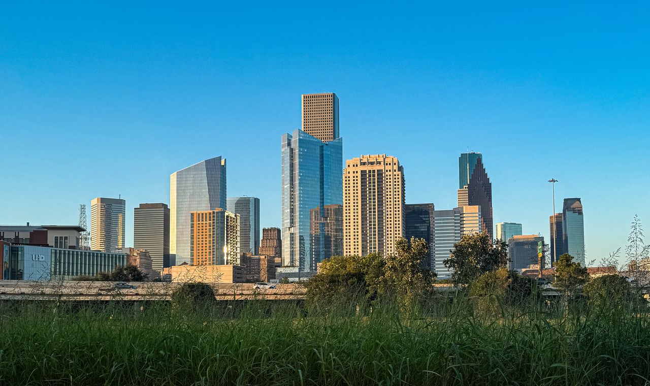The Houston skyline seen across open green space, the Gulf Coast market FinTruction supports with job costing and WIP reporting