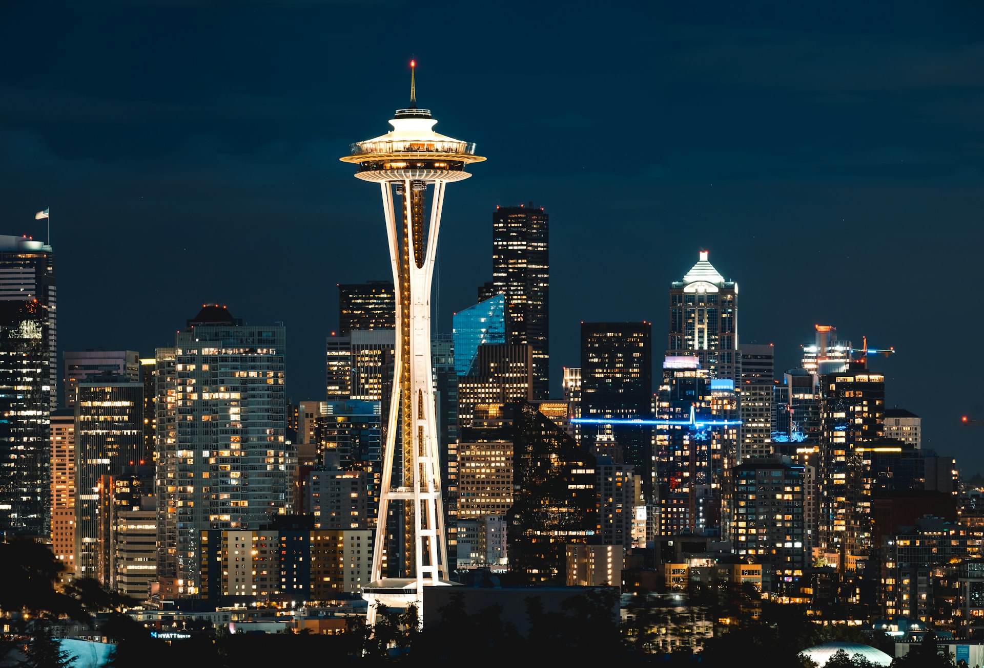 The Space Needle lit at night above the downtown Seattle skyline, the Puget Sound core of the Washington construction market FinTruction serves