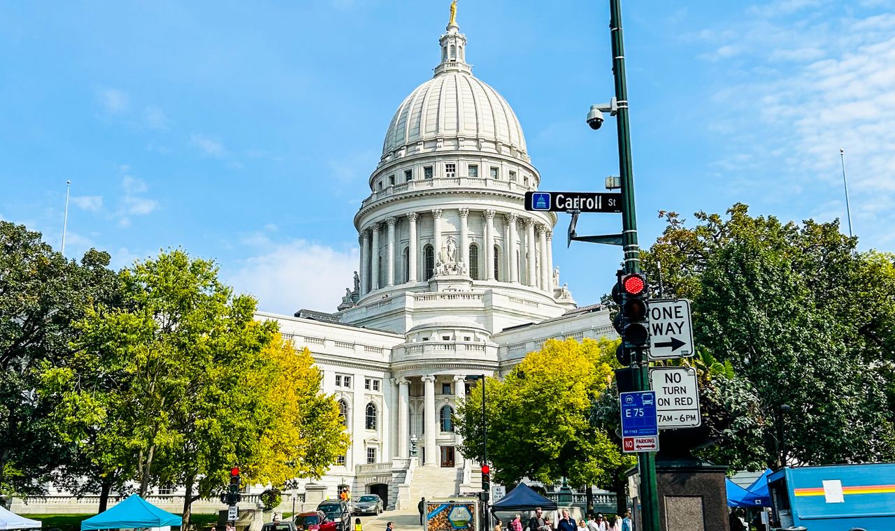 Wisconsin State Capitol dome above Carroll Street in daylight, the Madison market FinTruction serves with construction bookkeeping